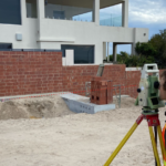 A retaining wall undergoes surveying to assess its stability as a part of Monitel's Strategic Partnership with Opifex Geotechnics in Perth.